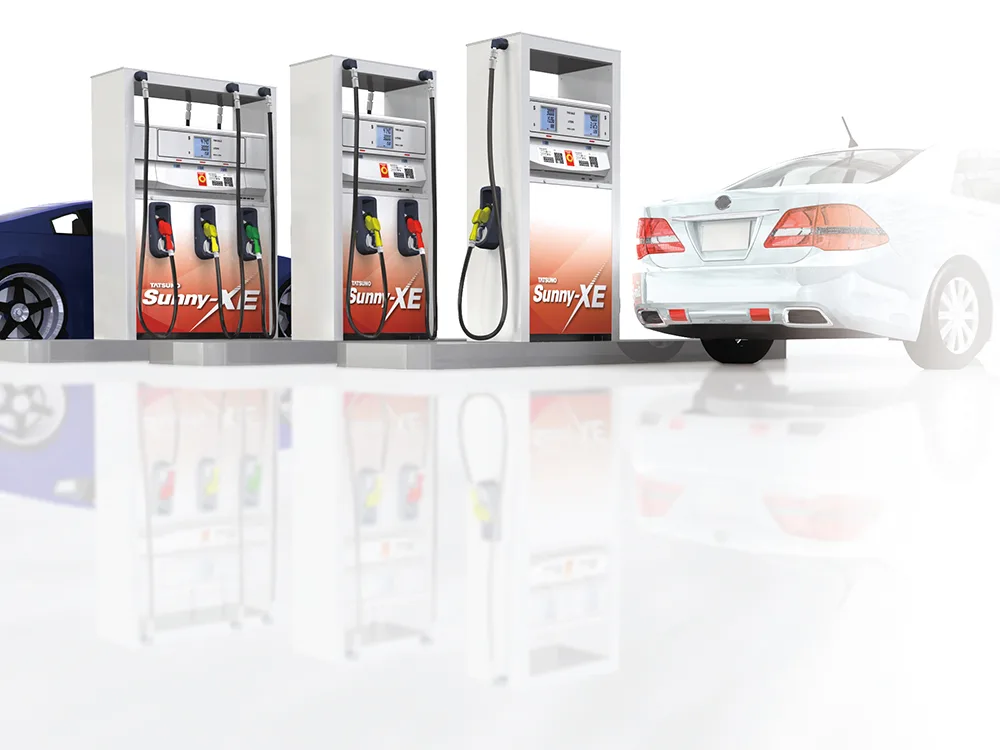 Three Tatsuno Sunny-XE fuel dispensers in different body widths beside a car on a forecourt