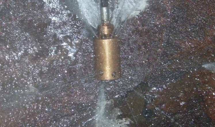 Wolftank TCR® rotating cleaning head washing the inside of a fuel tank